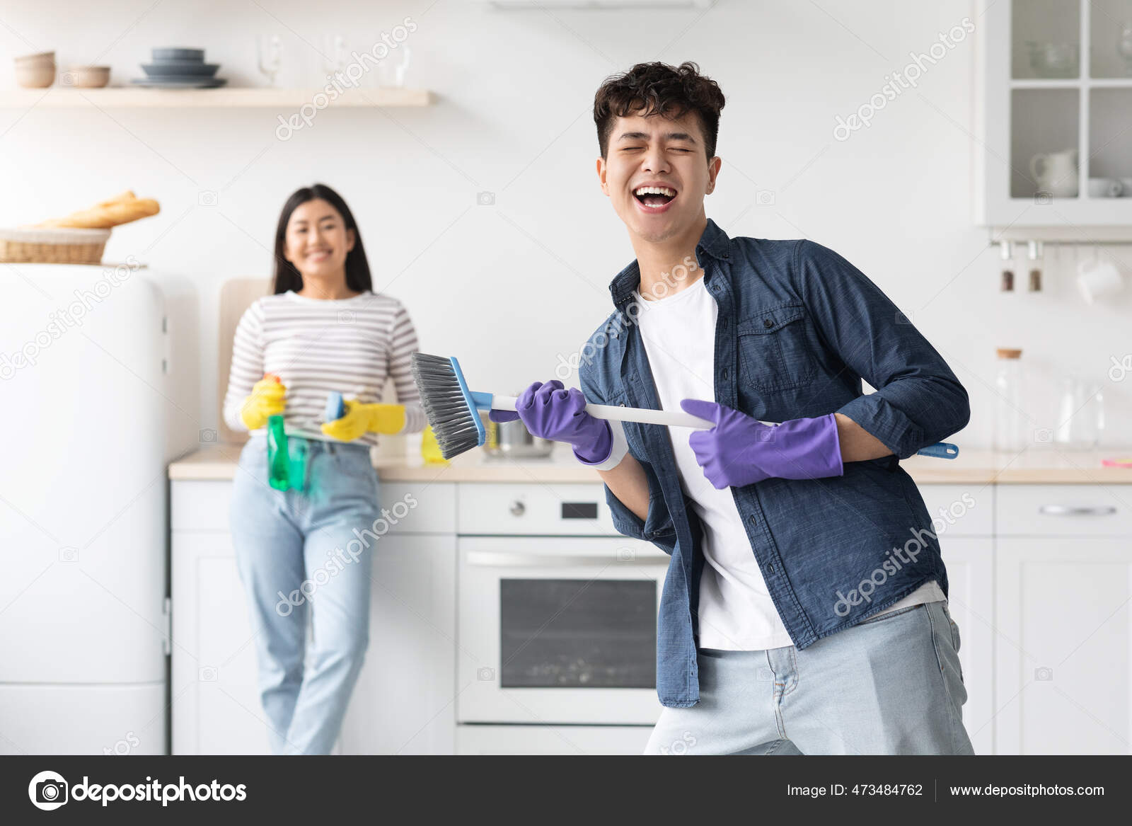 Funny asian guy imitating rock star while cleaning kitchen Stock Photo by ©Milkos 473484762 Funny asian guy imitating rock star while cleaning kitchen Stock Photo by ©Milkos 473484762