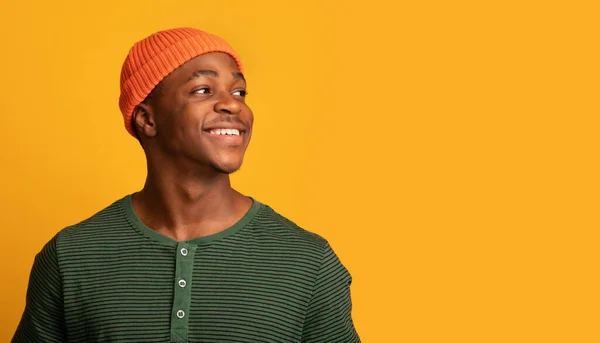 Cheerful Young Black Guy In Hat Looking At Copy Space With Interest — Stock Photo, Image