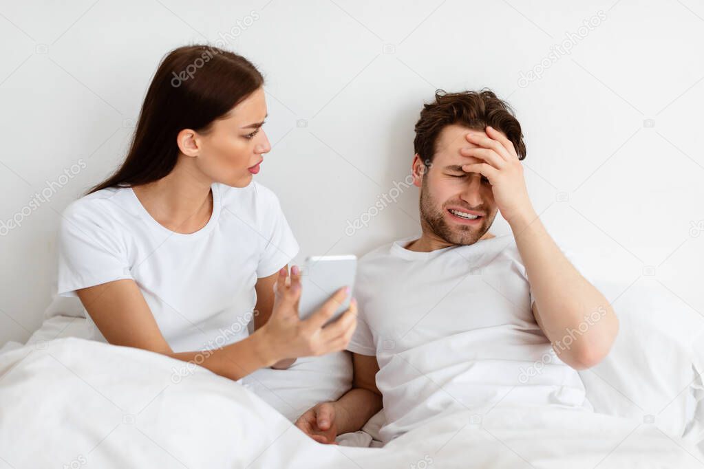 Jealous Wife Showing Cheating Husband His Phone Demanding Explanation Indoor