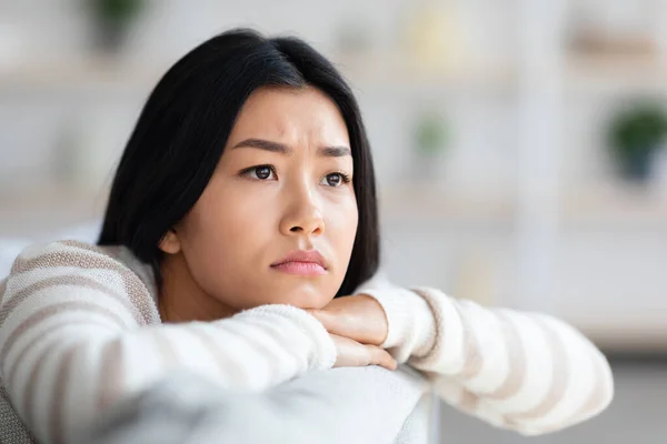 Depresyon Konsepti. Evdeki koltukta oturan üzgün Asyalı kadının yakın çekimi. — Stok fotoğraf