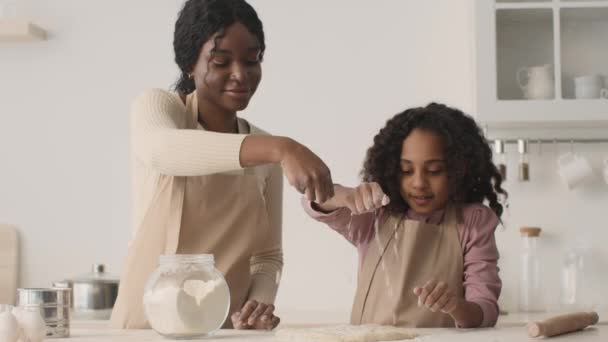 Wesoła afrykańska matka i córka wylewają mąkę na ciasto, przygotowując wspólnie ciasto w kuchni, zwolniony ruch — Wideo stockowe