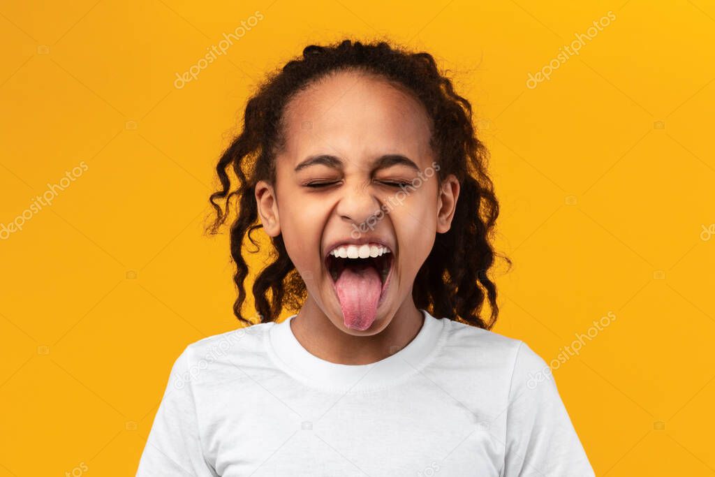 Naughty black teenage girl sticking out her tongue