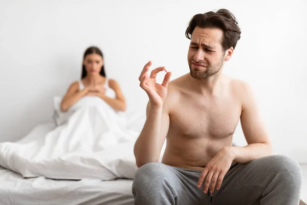 Unhappy Man Holding Potency Pill Before Sex In Bedroom Indoors — Stock Photo, Image