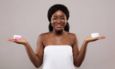 Best Cosmetics For Body Care. Beautiful African Lady Holding Jars With Cream clipart