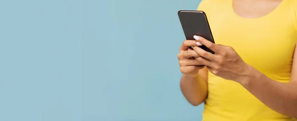 Gadget Sucht Konzept. Afroamerikanerin mit Smartphone über blauem Studiohintergrund, Panorama mit leerem Raum — Stockfoto