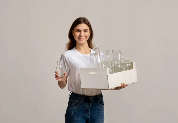 Happy Young Woman Collecting Garbage For Sorting, Holding Container With Glass Bottles — Stock Photo, Image