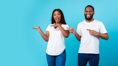 Gülümseyen siyah çift bedava fotokopi alanını işaret ediyor.