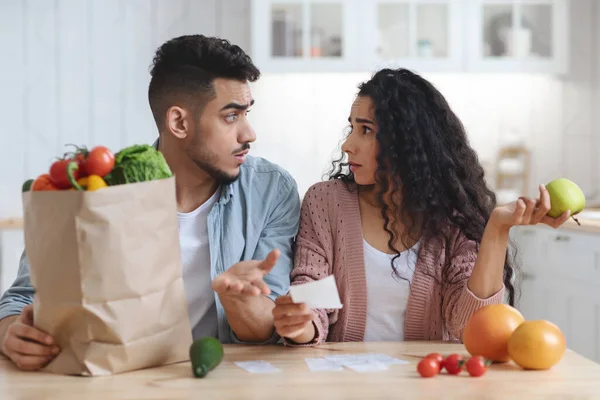 Prices Increase. Frustrated Young Arab Spouses Looking At Bills After Grocery Shopping — Stock Photo, Image