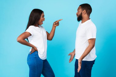 Black couple arguing, angry woman screaming at annoyed man clipart