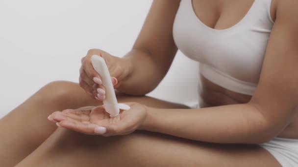 Close up shot of young african american woman applying lotion on hand before body care procedures, slow motion — Stock Video