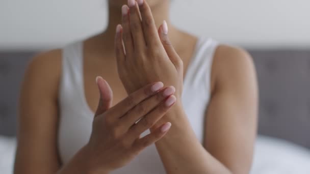 La mejor crema para la piel seca. Mujer negra irreconocible frotando loción hidratante en la palma de la mano, cámara lenta — Vídeos de Stock