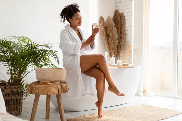 African American Young Woman Applying Hands Cream After Bathing Indoors — Stock Photo, Image