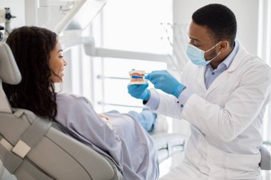 Diş hijyeni. Diş Hekimi Çene Modeli ve Diş Fırçalamayı Gösteriyor