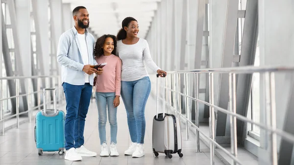Familia negra viajando, sosteniendo documentos en el aeropuerto — Foto de Stock