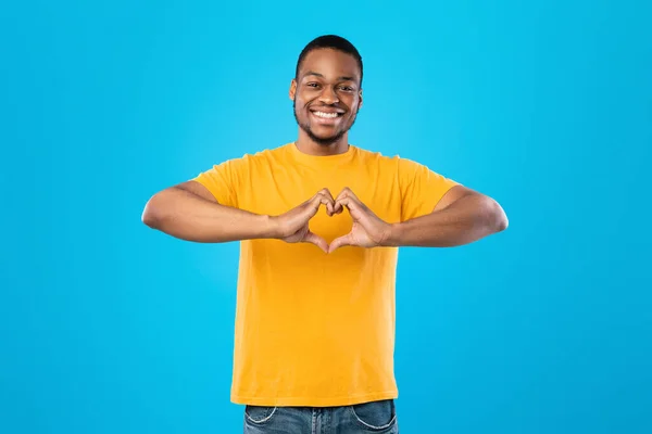 African American Guy Showing Heart With Fingers Over Blue Background — 스톡 사진