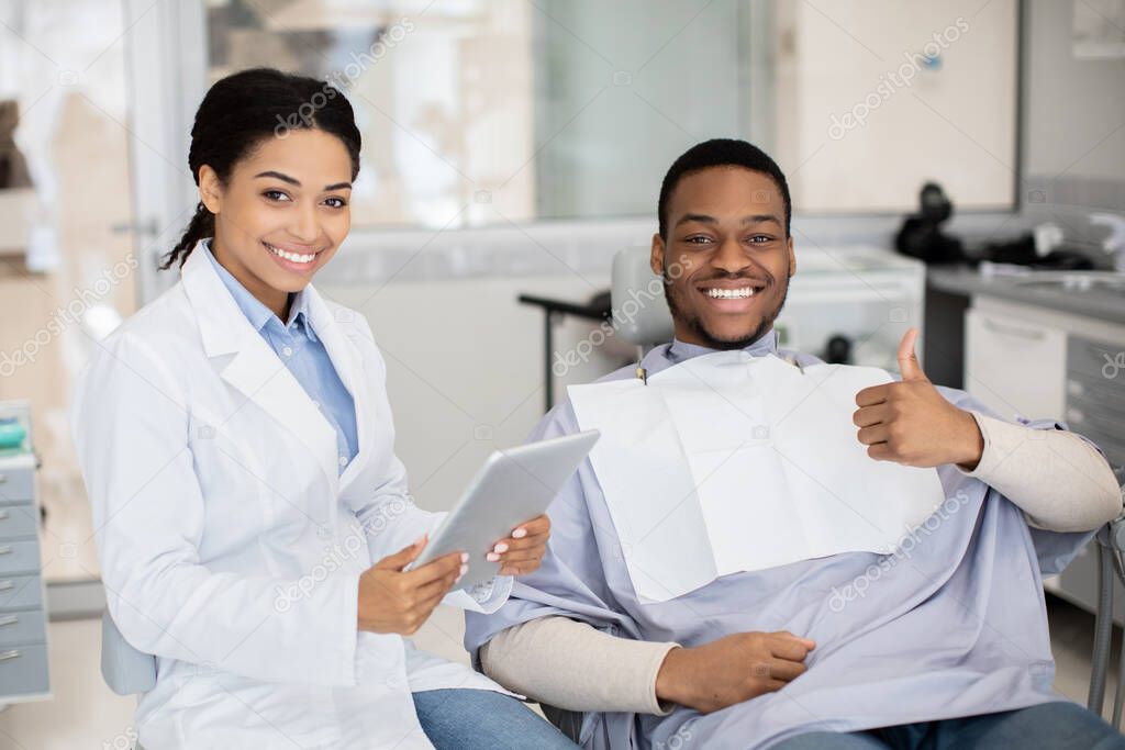 Happy Black Man Showing Thumb Up After Dental Treatment In Stomatologic Clinic