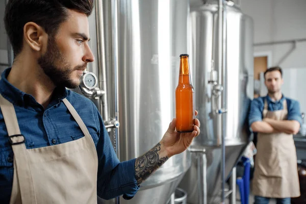 Small business and modern brewery. Owners check quality of drink — Photo
