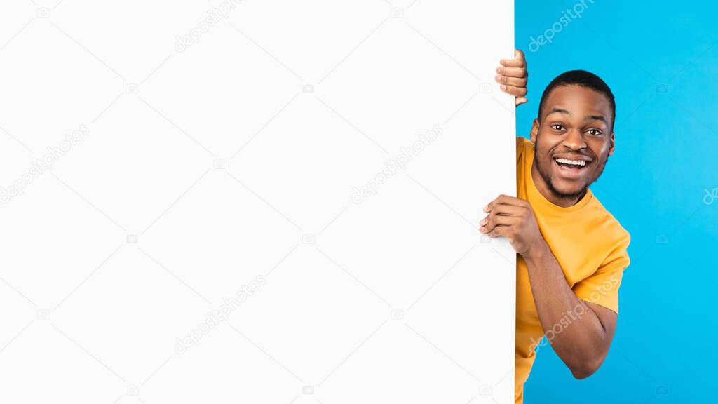 Excited African American Man Posing With White Poster, Blue Background