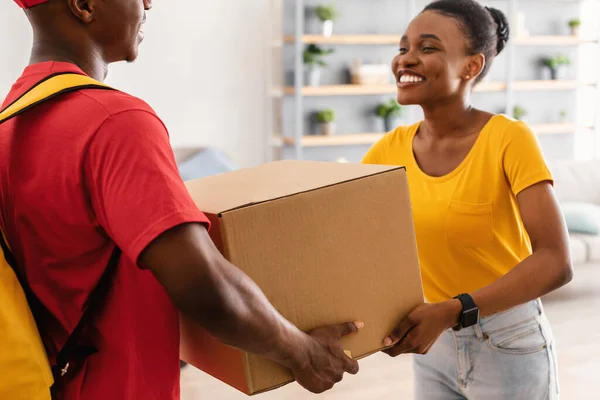 Happy African American Woman Receiving Box From Courier At Home — Stockfoto