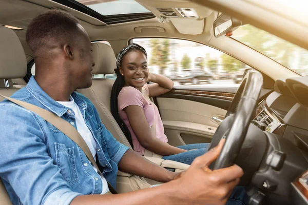 Smiling african amerfican man and woman sitting in luxury car —  Fotos de Stock