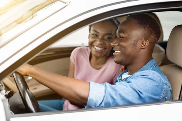 Cheerful black couple sitting in car together —  Fotos de Stock