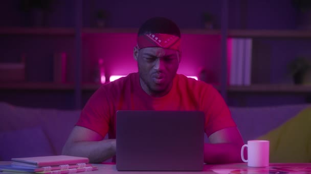 Emocional africano hombre mirando al ordenador portátil lectura malas noticias en interiores — Vídeo de stock