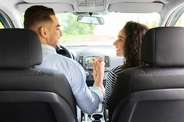 Liefdevol paar hand in hand zitten in auto — Stockfoto