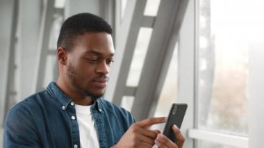Havaalanında telefon kullanan Afro-Amerikalı adam.