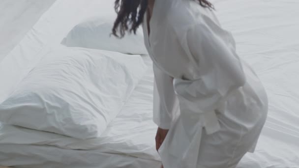 Concetto di dolore mestruale. Giovane donna afroamericana che soffre di mal di stomaco, sdraiata sul letto, toccando la sua pancia dolorosa — Video Stock