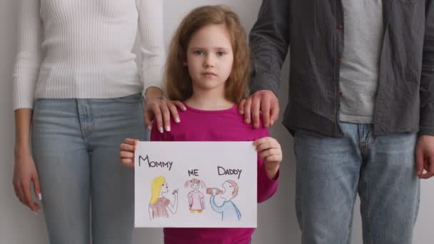 Unhappy little girl holding picture with father alcoholic and glamorous mother ignoring kid, feeling abandoned — Stock Video