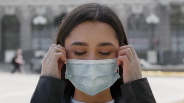 Boldog fiatal nő felszáll védő arc maszk pózol szabadban — Stock videók