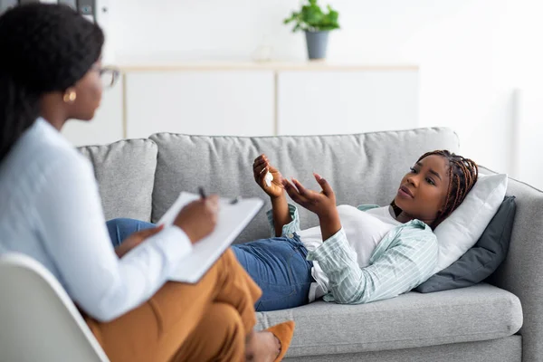 Stress and psychological trauma. Experienced psychologist working with depressed black woman at office — Stock Photo, Image