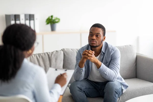 Psychological help service. Depressed male patient having psychotherapy session with counselor at mental health clinic — Stock Photo, Image