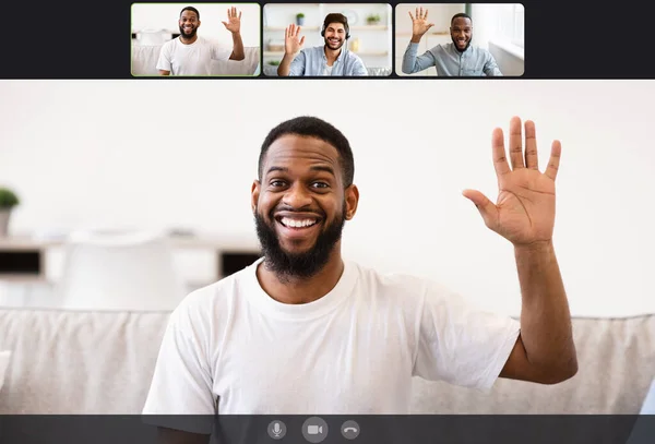 Youn men making online videochat at home, waving hands — Stock Photo, Image