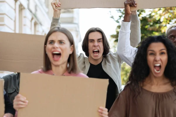 Closeup of furious multiracial protestors with empty placards — Stock fotografie