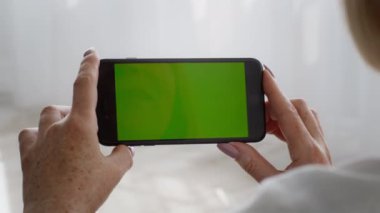 Tanımlanamayan Kıdemli Bayan Akıllı Telefonu Kapalı Kapalı Krom Anahtar Ekranlı Tutuyor