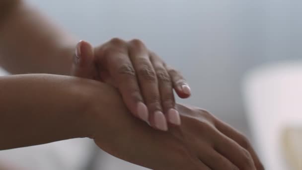 Skin protection on sunny days. Young african american woman applying sun protective lotion on her hands before going out — Stock Video