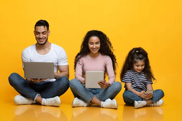 Family Gadgets. Young Middle Eastern Family Of Three Using Different Electronic Devices — Stock Photo, Image