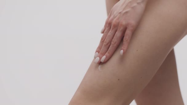 Close up shot of young woman applying pampering cream or lotion on her smooth hips, empty space — Stock Video