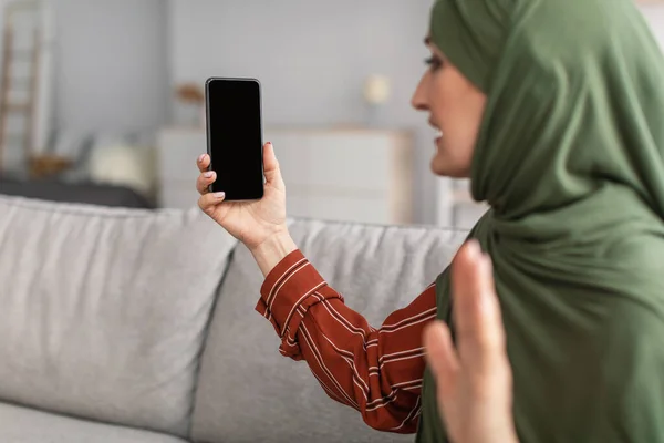 Mature Muslim Woman Making Video Call Via Phone Indoor, Mockup