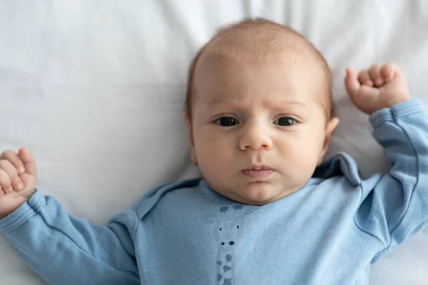 Closeup portret van schattige pasgeboren baby in blauw lichaam liggend op bed — Stockfoto