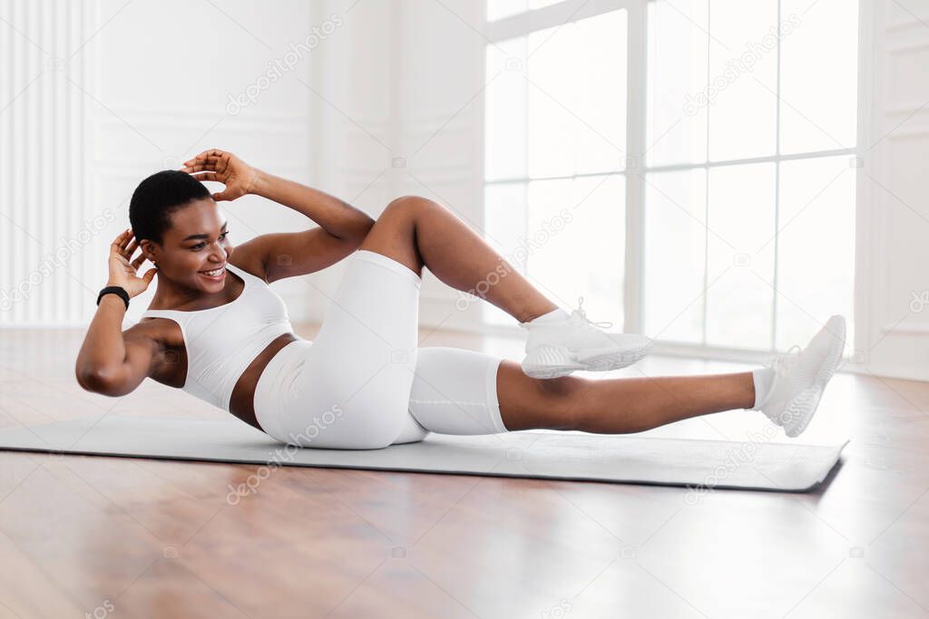Smiling Young Black Woman Doing Twist Crunches Exercise