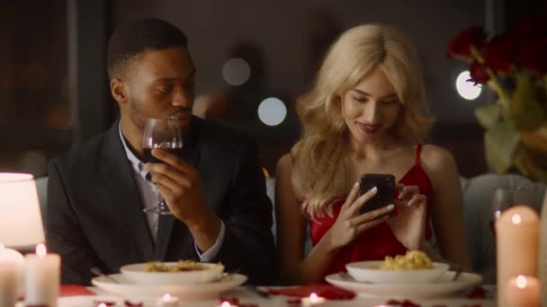 Marido ciumento suspeitando de caso enquanto esposa mensagens de texto durante o jantar interior — Vídeo de Stock