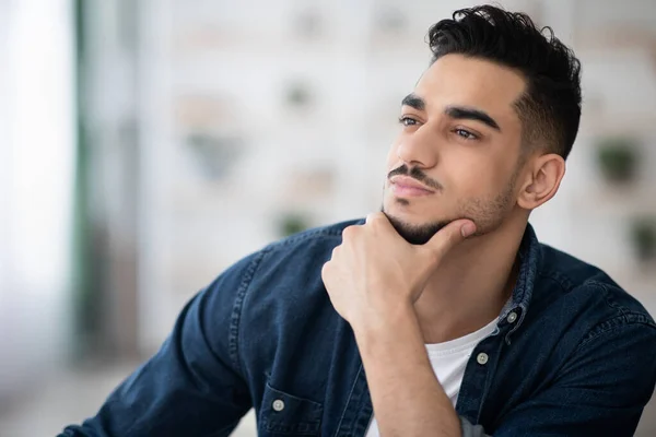 Pensive arab guy in casual sitting at workdesk, thinking — Stock Photo, Image