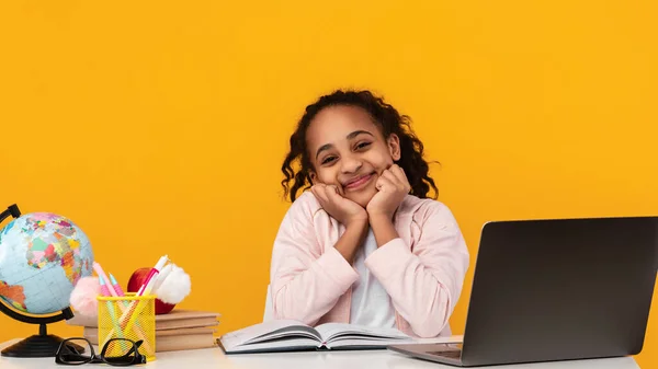 Cute Joyful African American Girl Touching Cheeks Sitting At Desk — Stock Photo, Image