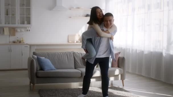 Asian Couple Having Fun Dancing, Boyfriend Carrying Girlfriend At Home — Vídeo de Stock