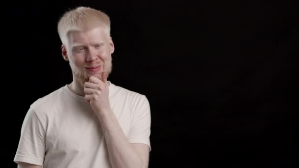 Positive Albino Guy Thinking Scratching Beard Posing Over Black Background — Video