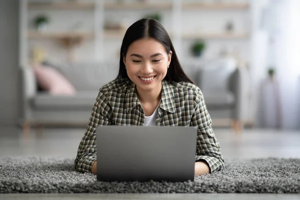 Relaxed asian woman looking for job opportunities at home