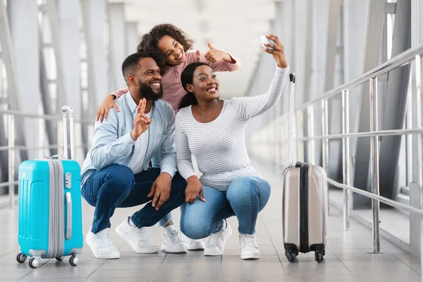 Familia negra de tres viajando, tomando selfie en el aeropuerto —  Fotos de Stock