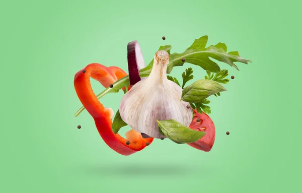 Bell-pepper, garlic and greens levitating in the air — Stock Photo, Image